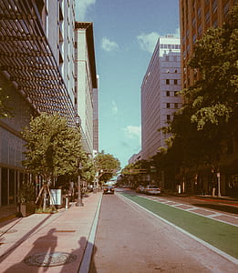 black vehicle parked near buildings on road thumbnail