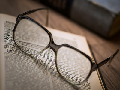 black framed eyeglasses on top of bookpage thumbnail