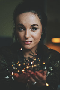 woman holding string lights thumbnail