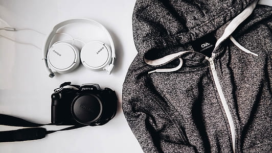 zip-up hoodie beside DSLR camera and Sony headphones thumbnail