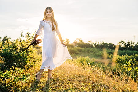 Woman Carrying Ukulele Posing for a Photo thumbnail