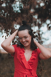 woman wearing V-neck top near plant during daytime thumbnail