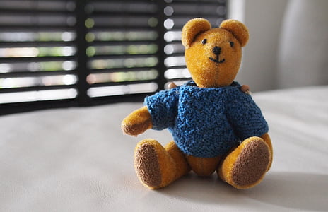 selective focus photo of blue and brown teddy bear on table thumbnail