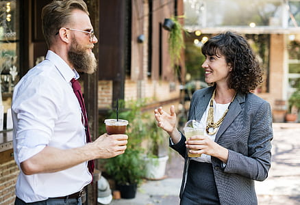 man and woman holding plastic cups thumbnail