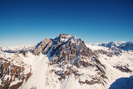 brown mountain covered by snow at daytime thumbnail