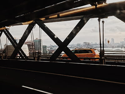 two orange and white cars on bridge thumbnail