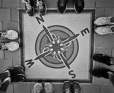 road painted with square compass surrounded by group of people wearing sneakers thumbnail