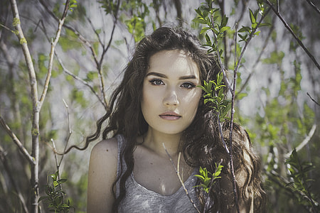 woman wearing gray sleeveless top near green plants thumbnail