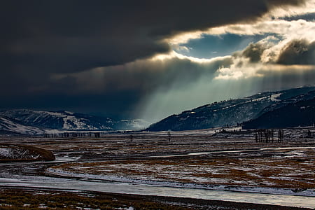 landscape photo of blue mountains covered with snow under cloudy sky during daytime thumbnail