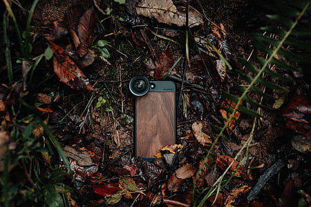 black and brown iPhone case with attached clip lens thumbnail