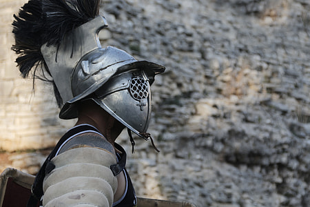 man with soldier helmet near the gray cliff photo thumbnail