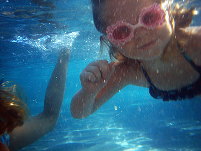 toddler wearing pink swimming goggle under the body of water thumbnail