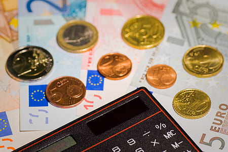 turned off calculator with banknote and coins thumbnail