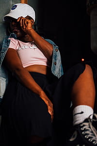 Woman Wearing Pink Crop Shirt and White Baseball Cap thumbnail