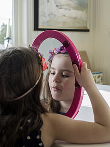 person holding oval pink mirror thumbnail