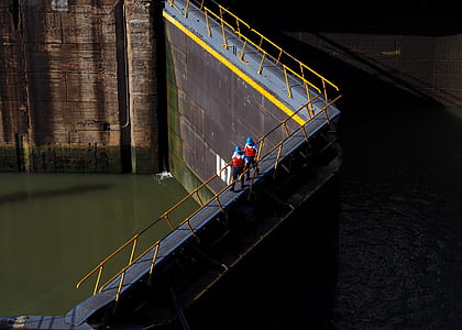 two persons walking between guardrails at daytime thumbnail