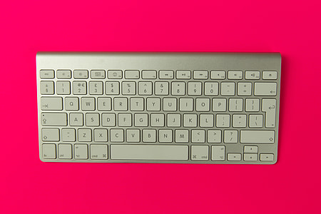 Apple wireless keyboard on pink background thumbnail