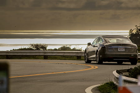 black sedan on the road thumbnail