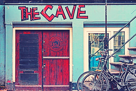 Black Beach Cruiser Bike Beside the Red Wooden Door Outside thumbnail
