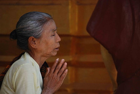 woman praying with close eyes during daytime thumbnail