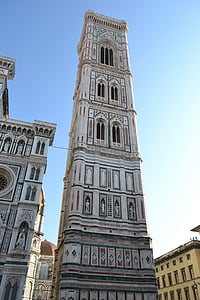 grey tower with windows under clear blue sky thumbnail