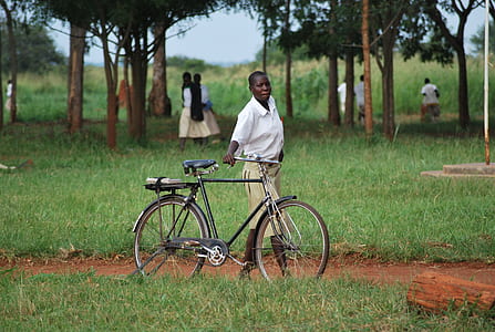 person holding gray bicycle thumbnail