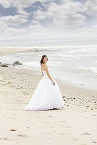 woman in white tube wedding dress standing on seashore on daytime thumbnail