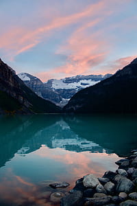 gray mountains across body of water at daytime thumbnail