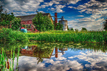 body of water near brown house at daytime thumbnail