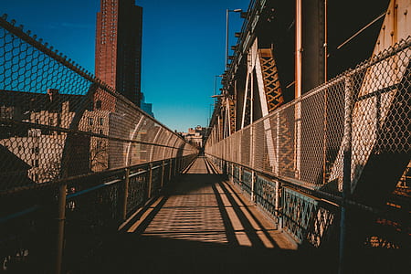 brown wooden bridge under clear blue sky during daytime thumbnail