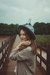 woman holding her brown hair thumbnail