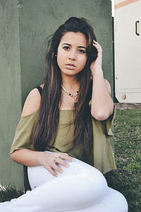 woman in green off-shoulder shirt and white pants thumbnail