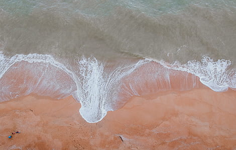 Calm Body of Water Beside Sand thumbnail