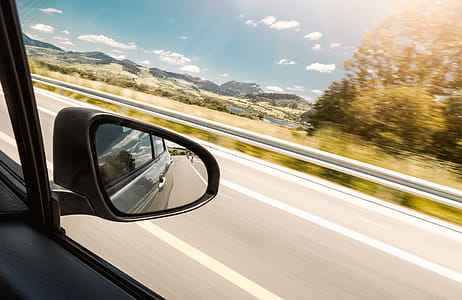 The reflection in the rear-view mirror of car in motion thumbnail