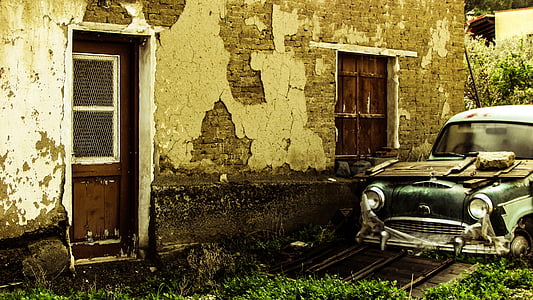 classic green vehicle parked near brown concrete house thumbnail