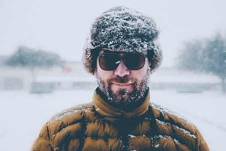 man standing in the middle of snow covered field thumbnail