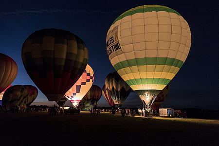 assorted hot air balloons on grass field thumbnail