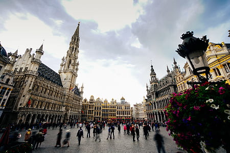people on street surround by concrete buildings thumbnail