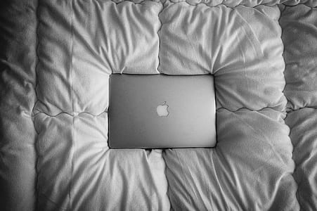 space gray MacBook pro on bed thumbnail