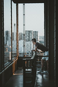 man leaning on baluster on terrace thumbnail