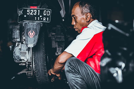 Selective Focus Photo of Man Looking on Motorcycle thumbnail