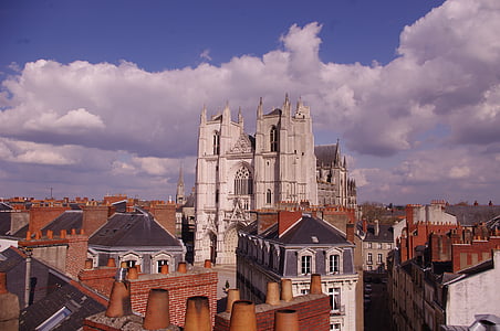 white and orange concrete buildings under blue sky during daytime thumbnail
