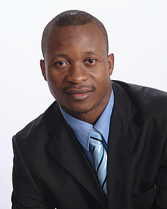 man wearing black suit jacket and blue striped necktie thumbnail