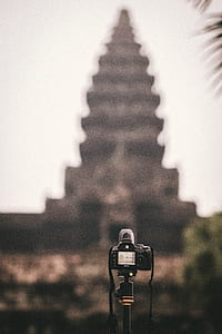 black DSLR camera taking picture temple thumbnail