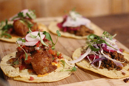 selective focus photo of roti with meat and vegetable toppings on brown wooden tray thumbnail