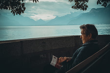 man sitting on a bench fronting a baywalk thumbnail