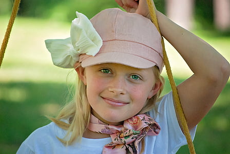 woman wearing white crew-neck t-shirt and pink cap thumbnail