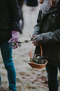 woman holding brown wicker basket during daytime thumbnail