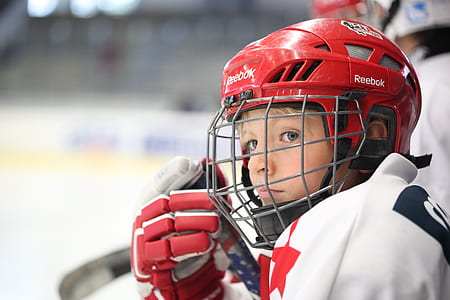 boy in red Reebok helmet and white jersey thumbnail