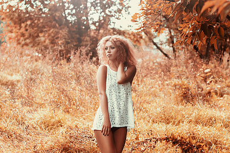 A woman wearing a dress in the Autumn grass thumbnail